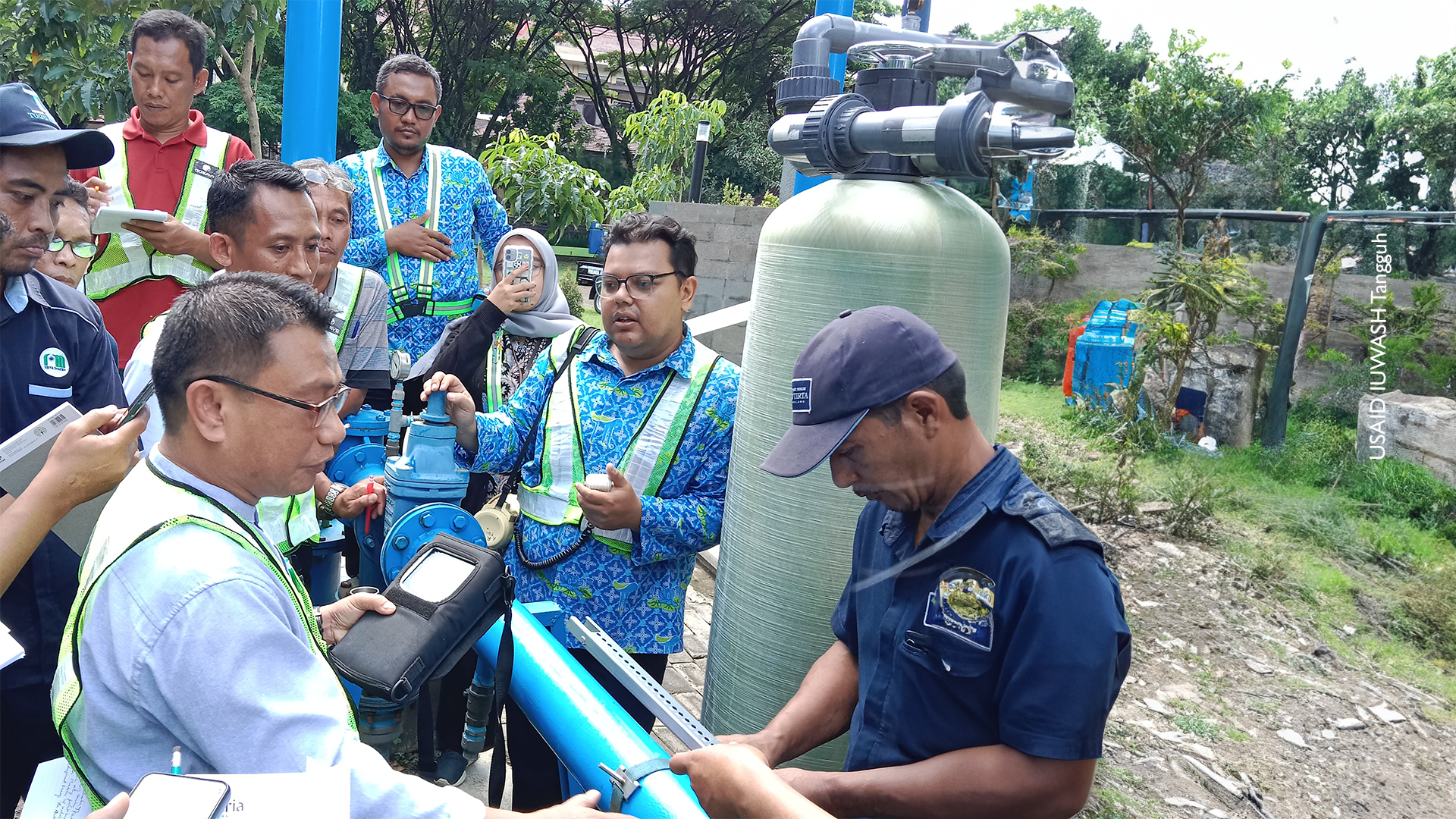 Training participants learn measure water flow in a pumping system